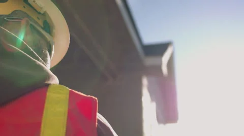 Low angle portrait of construction worker wearing safety gear on sunny day Stock Footage 55150133