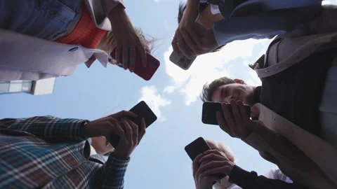 Low-angle portrait of a group of friends, all dressed in stylish outfits, use Stock Footage 297468344