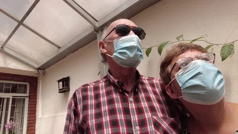 Low Angle Portrait of a latin elderly senior couple wearing face mask pandemic Stock Footage 147570541