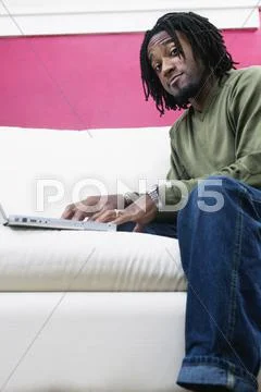 Low angle portrait of man with laptop Stock Photos