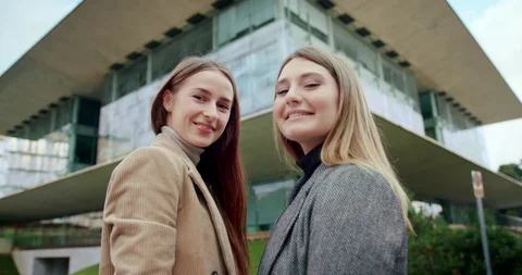 Low angle portrait shot of two young cute successful female business student Stock Footage 120748136