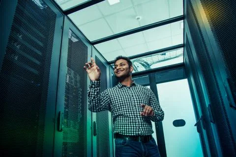 Low angle of a positive smart man using virtual technology Stock Photos