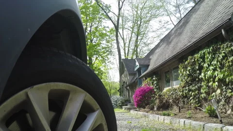 Low angle POV: Car pulls out of driveway of cozy New England Suburban Home Stock-Footage 131135143