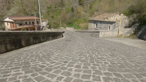 Low-Angle POV Driving on Cobblestone Road Towards Cerro al Volturno, Italy 動画素材 332429494