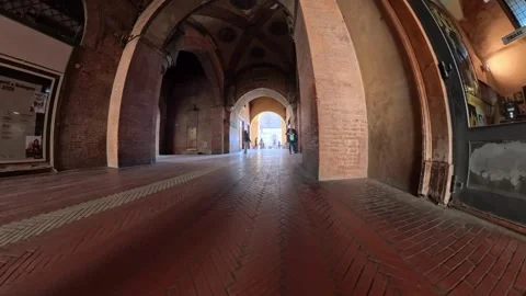 Low Angle POV of Empty Covered Walkway with Arches and Brick Pavement in Stock Footage 329013203