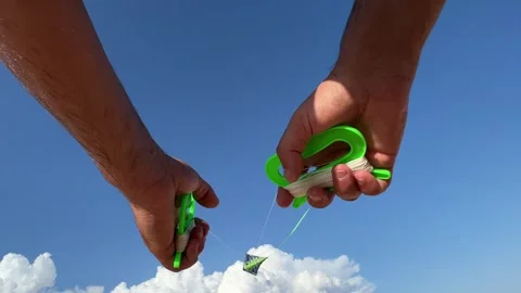 Low angle pov of hands holding kite handles in sky Vídeo Stock 277516887