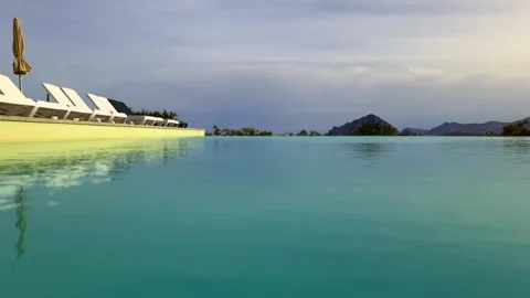 Low angle pov of infinity pool with monte cofano in background slow motion 库存影片 278962658