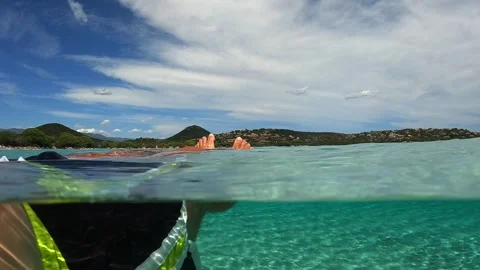 Low angle pov of man floating on seawater at santa giulia Stock Footage 279432183