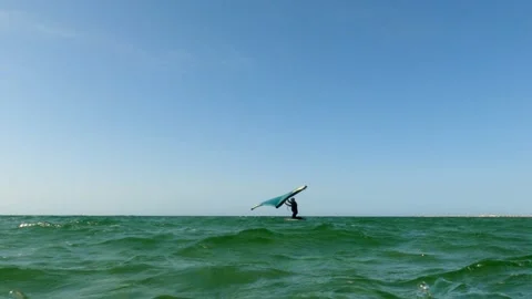 Low angle pov of man on kite board wing surfing on sea surface. Stock Footage
