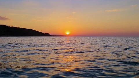 Low angle pov moving backwards on seawater at sunset Stock Footage 278859729