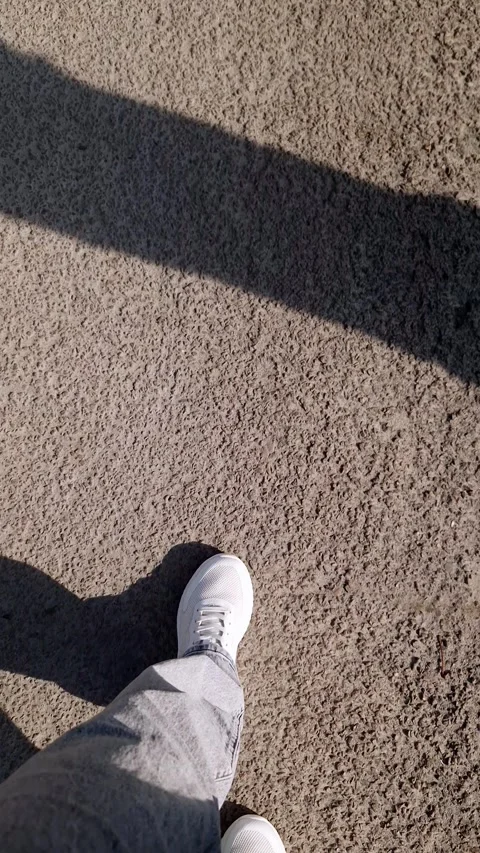 Low Angle Pov of Person in White Sneakers Walking on Asphalt Pavement 스톡 동영상 338994954
