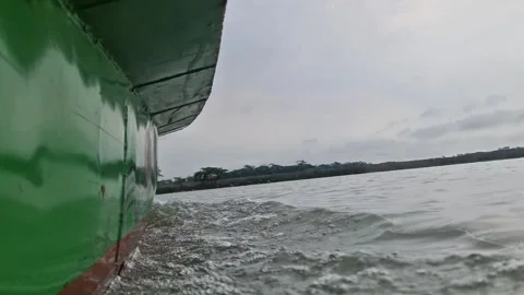 Low angle POV of steel engine boat moving on river with water splash Video stock 332503639