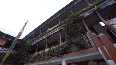 Low angle of prayer flags guesthouse building in Nepal Stock Footage 91434165