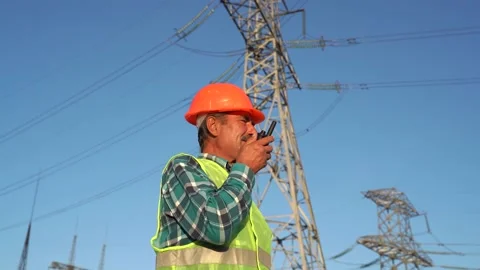 Low angle of professional electrician technician in hardhat and waistcoat Stock Footage 143673356