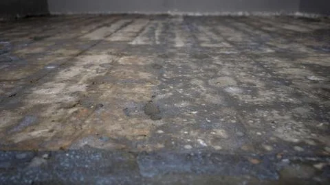 Low angle pull back shot of a rough concrete floor Stock Photos