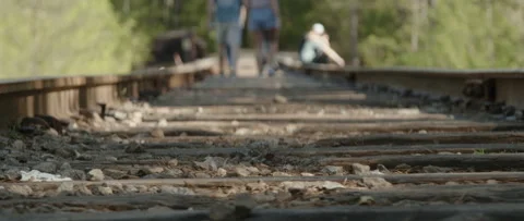 Low Angle Railroad Tracks with Defocused People in Background Video stock 133016427