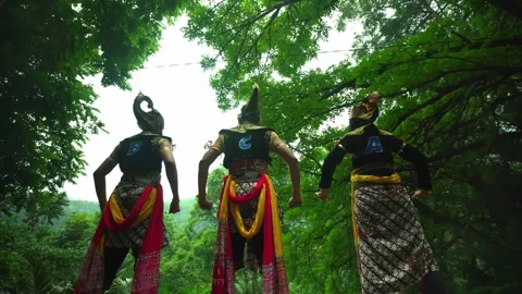 Low Angle Rear View of Javanese Dancers in Forest Setting Stock Footage 276348402