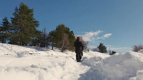 Low angle of red-haired girl throwing snowballs to mom Видео 279840831