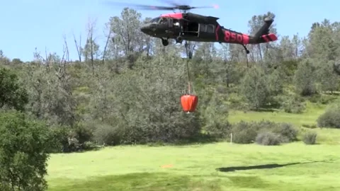 Low Angle of Rescue Helicopter Taking off With Helicopter Bucket Stock Footage 130589939
