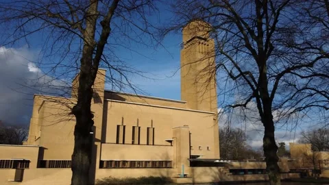 Low angle reveal dolly shot of Hilversum Town Hall in Winter with blue sky a Stock Footage 147880207