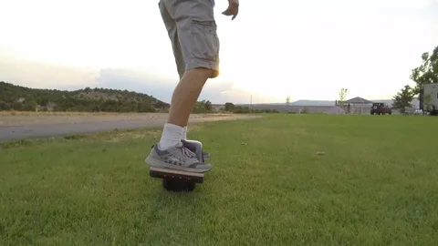 Low Angle Riding OneWheel on Grass Stock Footage 97651096