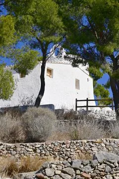 Low angle right view of La Magdalena Hermitage access among Mediterranean Pine Stock Photos