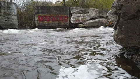 Low angle of a river flowing between two rocky shores Stock Footage 143197726