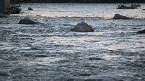 Low angle river flowing downstream. Rocks in water Stock Footage 135048278