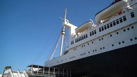 Low angle of riveted hull &amp; lifeboats, 1930s ocean liner Queen Mary Stock Footage 116509186