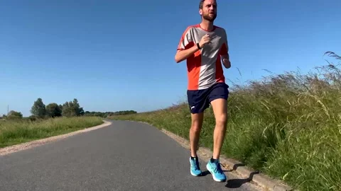 Low angle from road showing male trail Stock Video Pond5