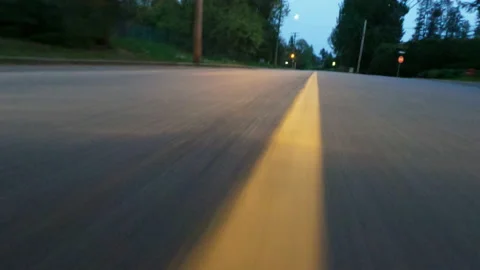 Low angle roadshot of car driving early evening swerving Vídeos de archivo 154655904