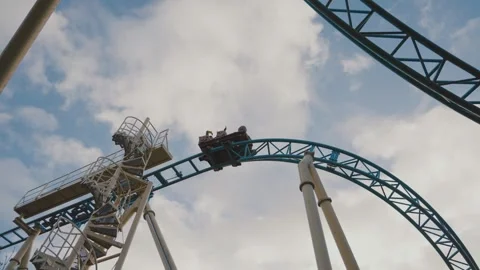 Low-Angle Roller Coaster Ride Against Blue Sky Adventure Theme Stock Footage 307939934