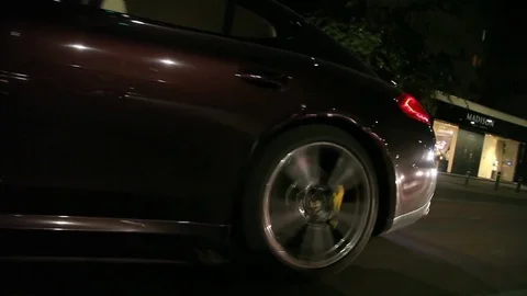 Low angle rolling shot of a Porsche Panamera in traffic at night Video stock 70817071