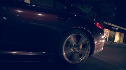 Low angle rolling shot of a Porsche Panamera in traffic at night Video stock 78939039