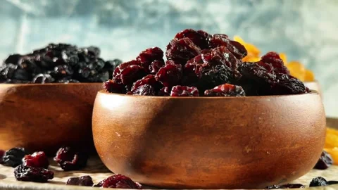 Low angle rotating display of three raisin varieties in wooden bowls with s.. Stock Footage 339462731