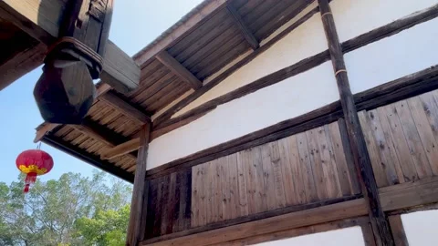 Low angle rotating shot of traditional Asian wooden buildings, Video stock 154438890