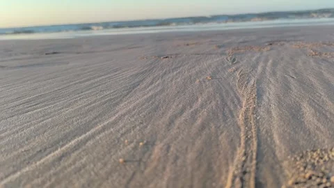 Low Angle Sand Ripples on Peaceful Beach with Soft Ocean Waves Stock Footage 340215814