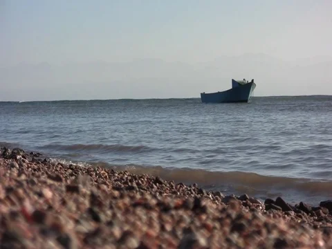 Low angle sand waves with boat Stock Footage 71476225