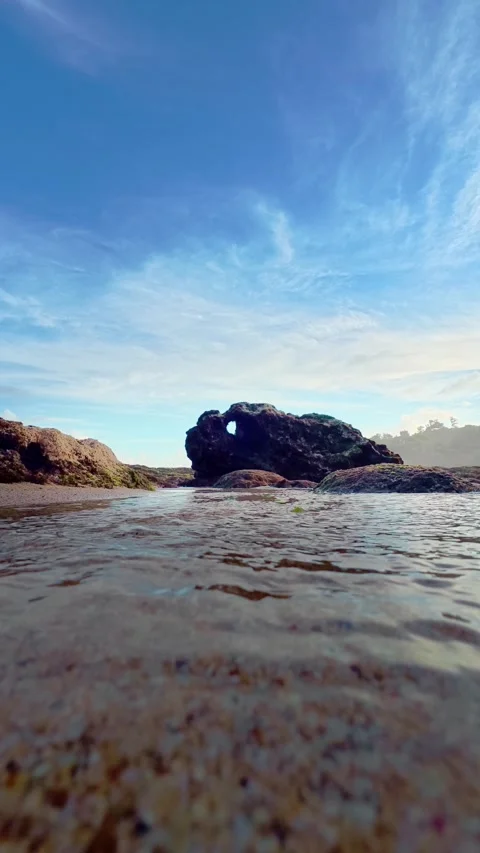 Low angle sandy beach with distant rocks Stock Footage 335442603