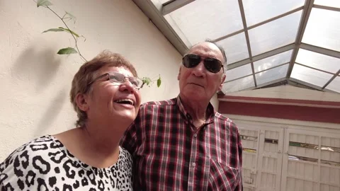 Low angle scene of latin elderly or senior couple smiling at camera indoors Stock Footage 147570259