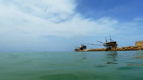 Low angle sea-level pov of trabocchi at punta penna slow motion Stock Footage 279850623