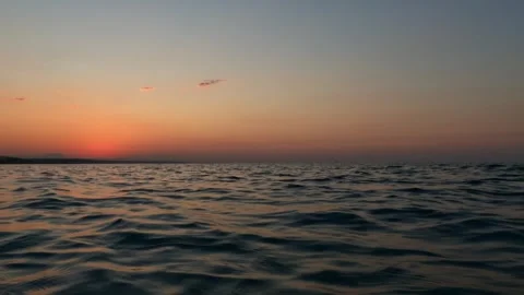 Low-angle sea-level pov from boat navigating at sunset, slow-motion Stock Footage 279865780