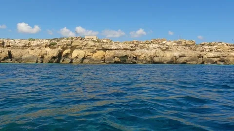 Low-angle sea-level view from boat at favignana island Stock Footage 277544046