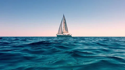 Low angle sea level view of yacht sailing at sunset Vídeo Stock 278957209