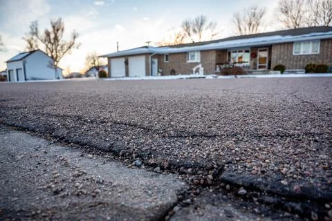 Low angle selective focus on asphalt overlay paving on top of a concrete base of Stock Photos