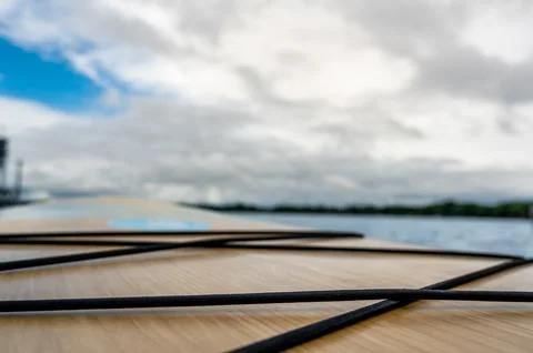 Low angle selective focus on shock cord on the deck surface of a paddle board Stock Photos