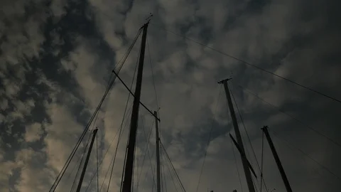 A Low Angle of several Ship's Masts against a Cloudy Sky Stock Footage 92747985