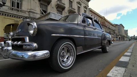 Low angle shoot of Iconic Classic 1950's American Vintage Cuban Car driving  Stock Footage 99757232