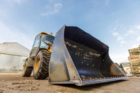 Low angle shoot of a small tractor or escavator. Industrial concept. Stock Photos