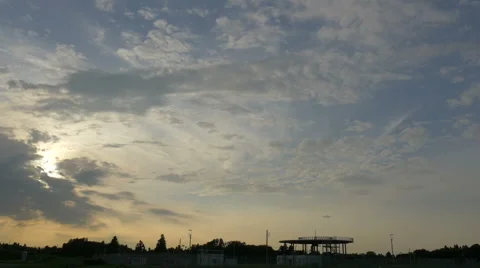 Low angle shot of an airplane descending to touchdown in sunset cloudscape. Stock Footage 61669698